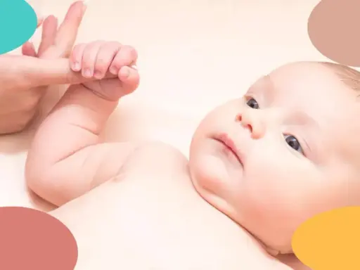 Bebé de 2 meses con ojos curiosos, agarrando un dedo. Una imagen tierna para la rutina de sueño bebe 2 meses.